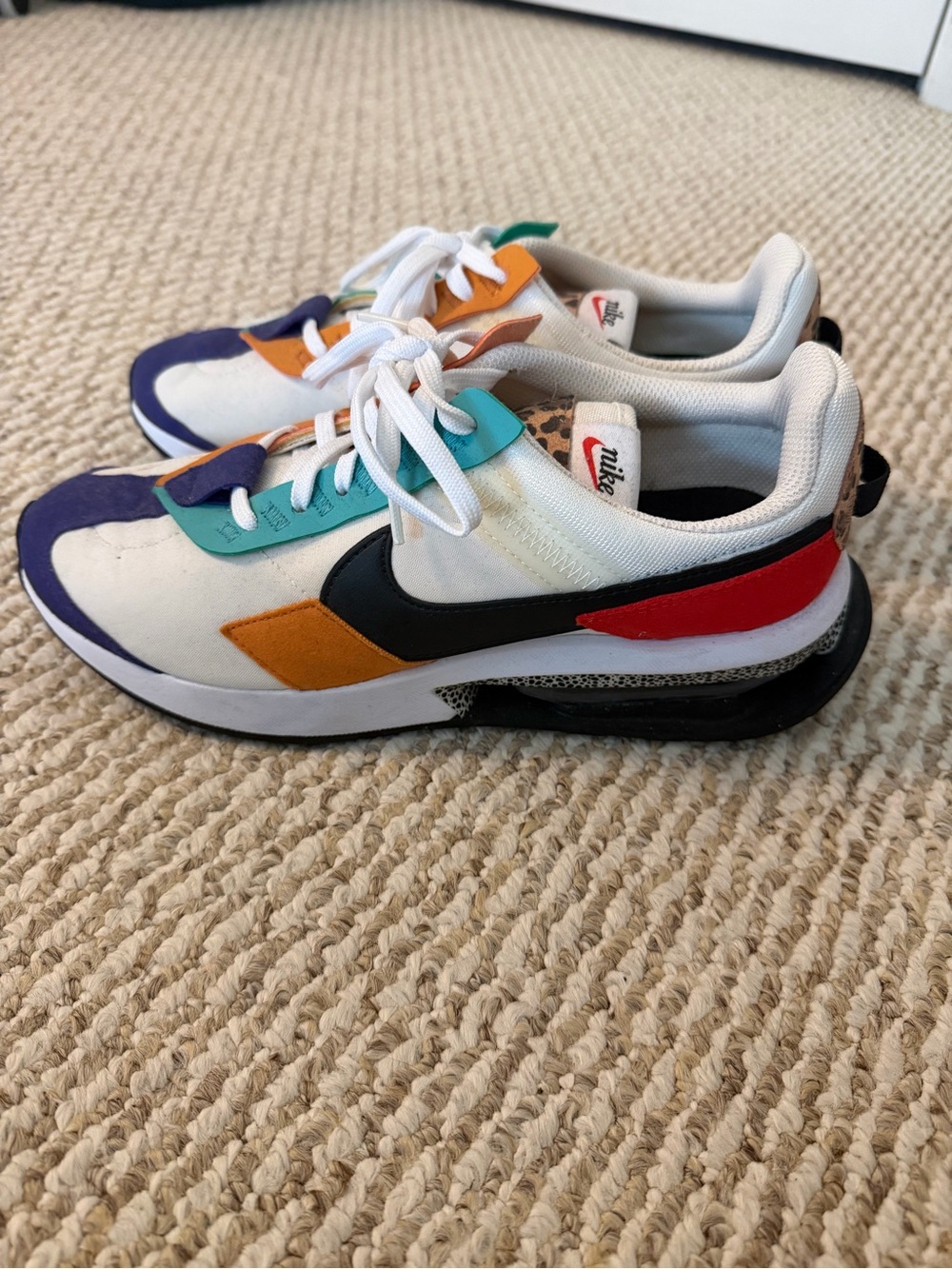 Nike White Sneakers with Purple, Teal, Orange & Red Accents